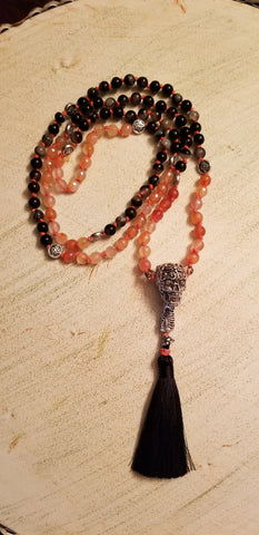 Hand Knotted, Zen Black & Fire Agate Mala with a Twisted touch. A Brass Skull Guru bead